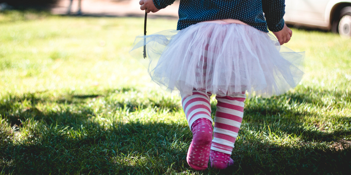 Image of little girl in tutu on grass