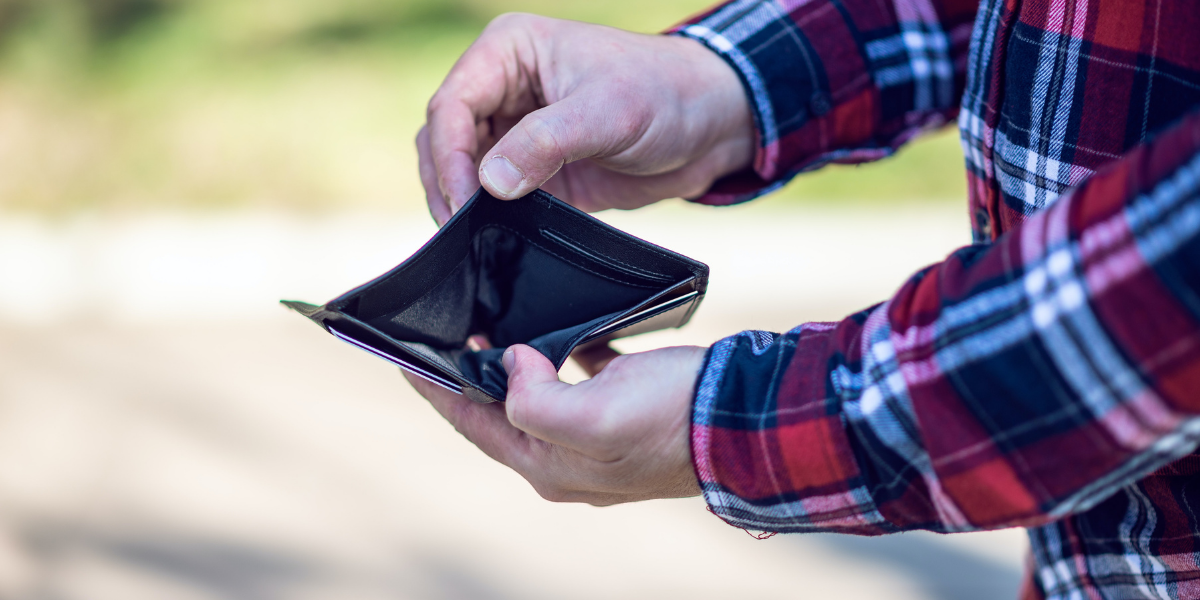 Image of a man holding out an open empty wallet